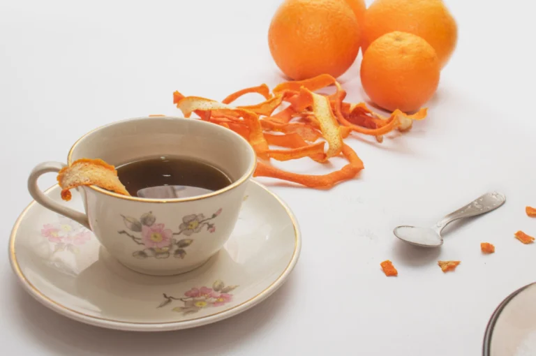 কমলালেবুর খোসা ফেলবেন না, বানিয়ে নিন এই ইমিউনিটি ড্রিংক │ Orange Peel Tea Benefits orange peel tea benefits with cup of herbal orange tea and dried orange peels on table