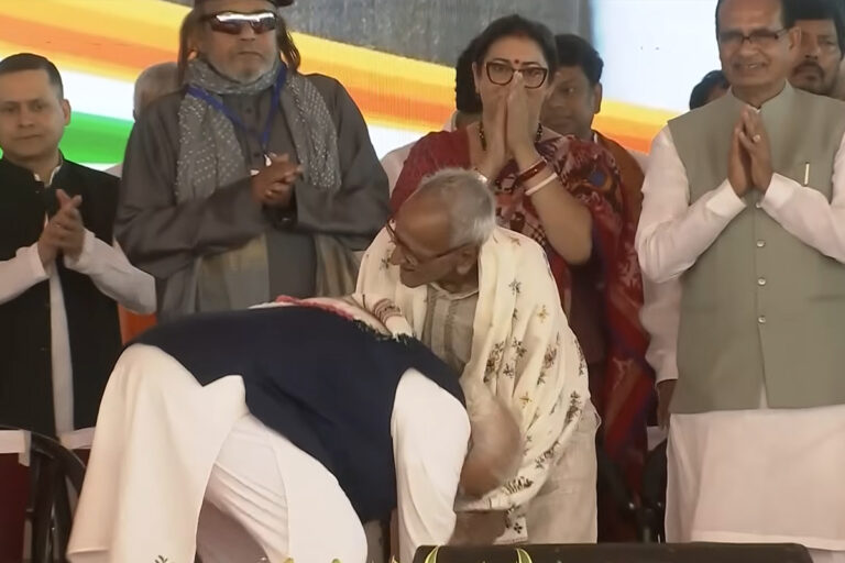 PM Narendra Modi touching the feet and putting a shawl on 98-year-old veteran BJP worker Makhan Lal Sarkar during West Bengal CM oath ceremony