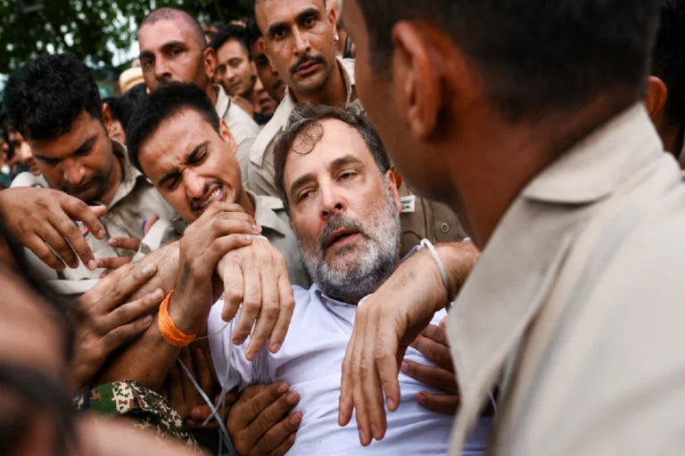 রাহুল গান্ধীকে ঘিরে দিল্লির রাজপথে টানটান উত্তেজনা, প্রতিবাদের সেই মুহূর্তে কী ঘটেছিল? Rahul Gandhi Detained during a Congress protest in Delhi over paper leak allegations, surrounded by police personnel at the protest site