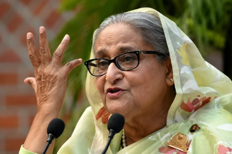 সব আশঙ্কা উড়িয়ে দেশে ফেরার ঘোষণা শেখ হাসিনার! কবে ফিরছেন জানুন Sheikh Hasina Return to Bangladesh – Former Bangladesh Prime Minister Sheikh Hasina speaks about her planned return to Bangladesh despite the death sentence and legal challenges.