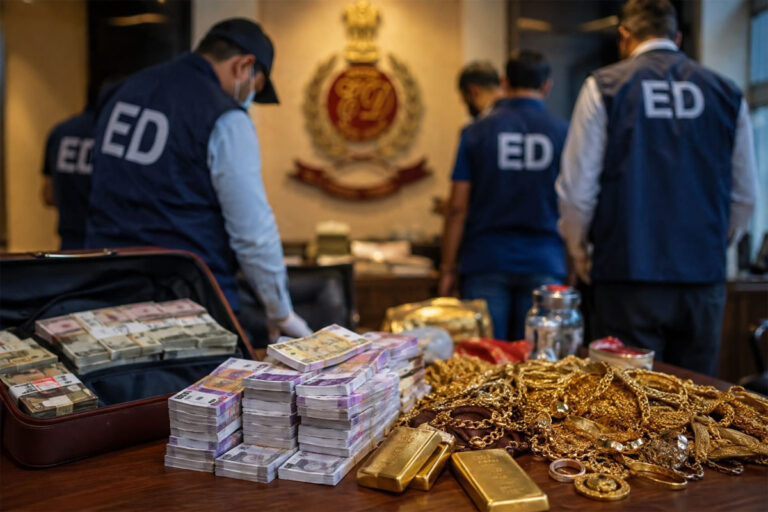 ইডির হানায় কোটি কোটি টাকা উদ্ধার! সেই টাকা শেষ পর্যন্ত কোথায় যায়? জানুন আসল নিয়ম! What Happens to Money Seized by ED: Cash, gold, and property documents seized by the Enforcement Directorate during a financial investigation.
