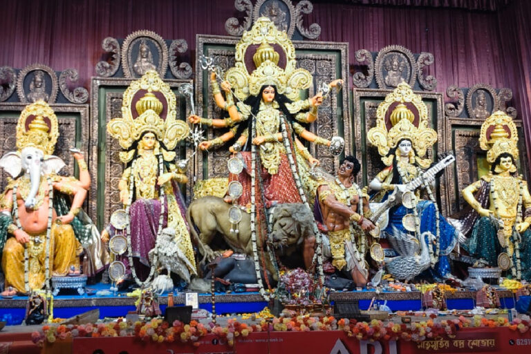 Kolkata Police Durga Puja Crowd Control 2026 – police personnel managing heavy visitor crowds at Kolkata Durga Puja pandals with special crowd-control equipment.