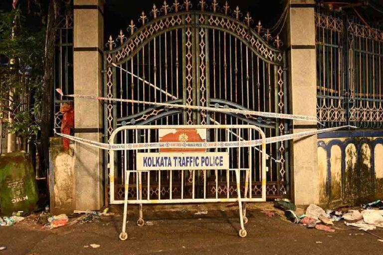 Chorbagan Stampede Postmortem Report 2026 – editorial illustration of a Kolkata hospital exterior and emergency medical personnel, representing reported postmortem findings following the Durga Puja crowd tragedy.